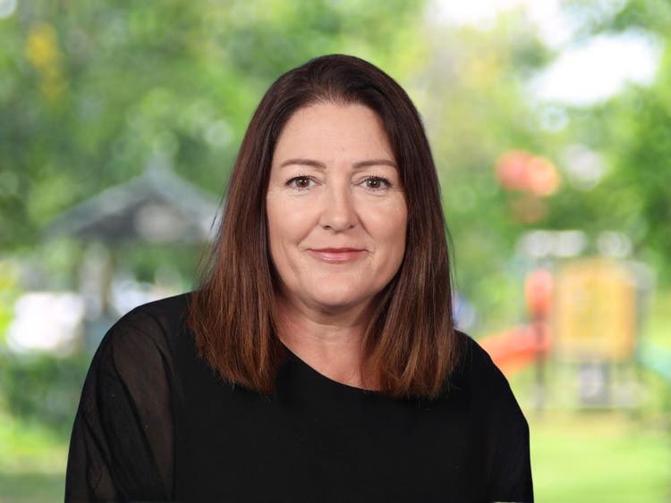 Maree Sterling wearing black top in front of blurred school playground